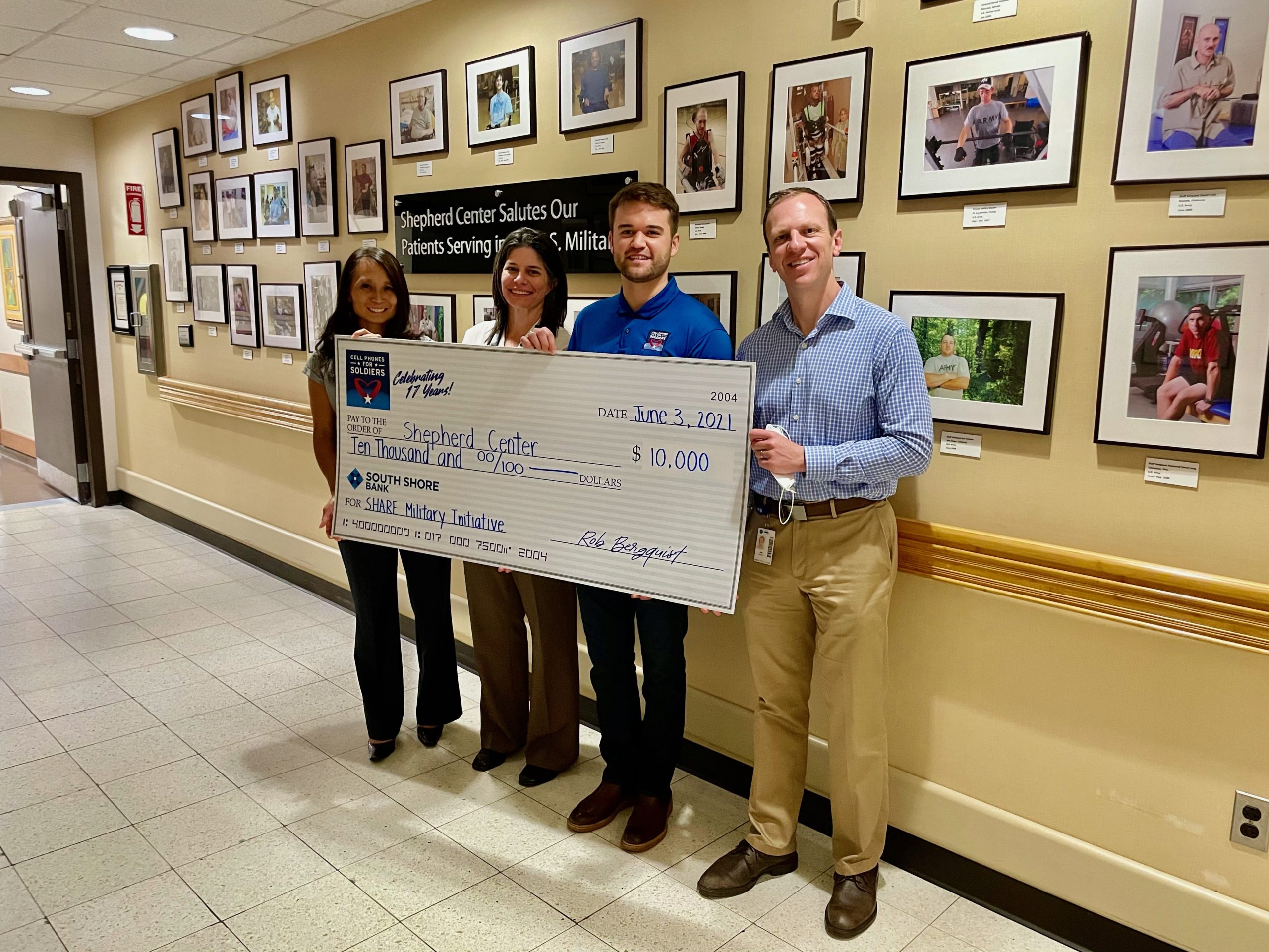 Cell Phones For Soldiers representatives present a $10,000 donation check to Shepherd Center for the SHARE Military Initiative.